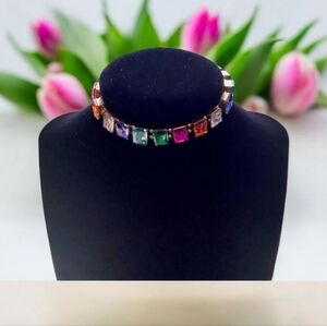 Bracelet with colored stones Stretchy gold tone background size large.